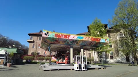 A children's carousel in a spring day in Italy Stock Footage 332238306