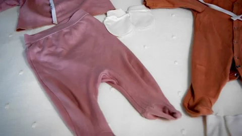 Children's clothes on the bed top view Vídeo Stock 221311683