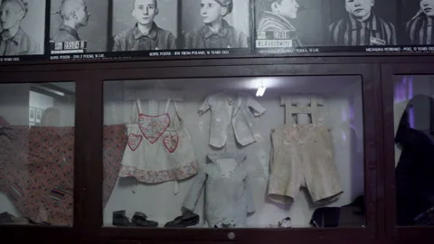 Childrens clothes on display at Auschwitz concentration camp museum Stock Footage 153065148