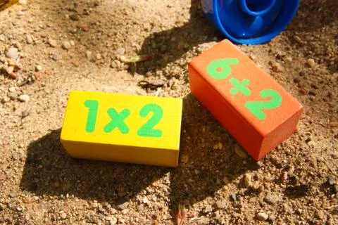 Children`s colored cubes in the sandbox Stock Photos