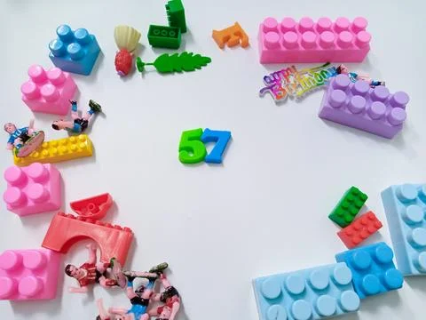 Children's colored plastic Block Bricks. Colorful kids toys frame on white .. Stock Photos