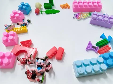 Children's colored plastic Block Bricks. Colorful kids toys frame on white .. Stock Photos