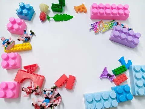 Children's colored plastic Block Bricks. Colorful kids toys frame on white .. Stock Photos