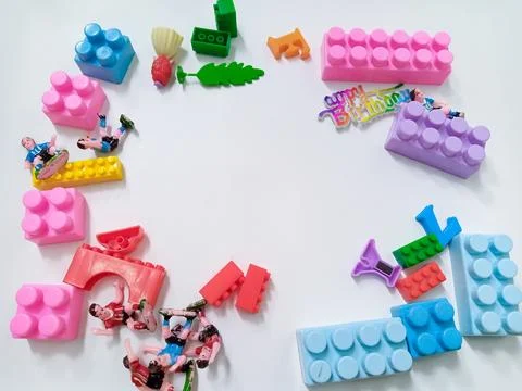 Children's colored plastic Block Bricks. Colorful kids toys frame on white .. Stock Photos