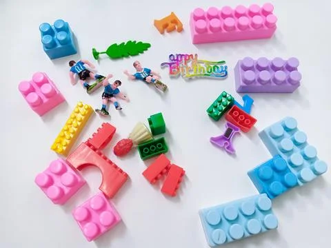 Children's colored plastic Block Bricks. Colorful kids toys frame on white .. Stock Photos