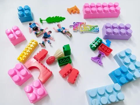 Children's colored plastic Block Bricks. Colorful kids toys frame on white .. Stock Photos