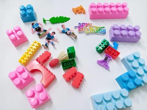 Children's colored plastic Block Bricks. Colorful kids toys frame on white .. Stock Photos