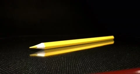 Children's creativity concept. Multi-colored pencils lying on a black surface Stock Footage 147036258