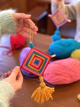 Children's creativity, a mandala made of colored yarn. Stock Photos