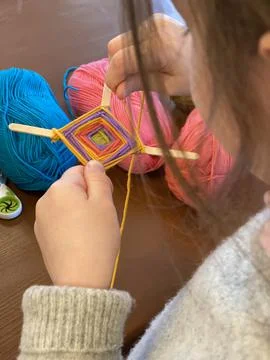 Children's creativity, a mandala made of colored yarn. Stock Photos