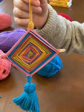 Children's creativity, a mandala made of colored yarn. Stock Photos