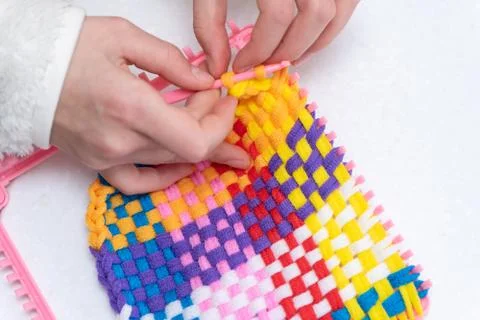 Childrens creativity weaving with colored threads ropes Stock Photos