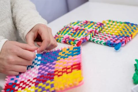Childrens creativity weaving with colored threads ropes Stock Photos