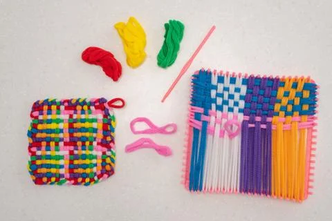 Childrens creativity weaving with colored threads ropes Stock Photos