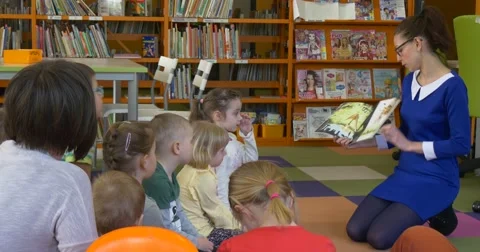 Children's Day in Opole Educator Tells the Story to Kids in a Classroom Shows a Stock Footage