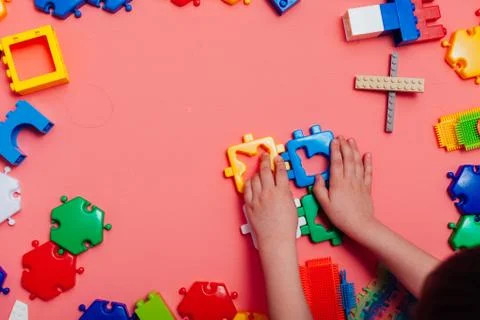 Children's developing games collect designer on a pink background Stock Photos
