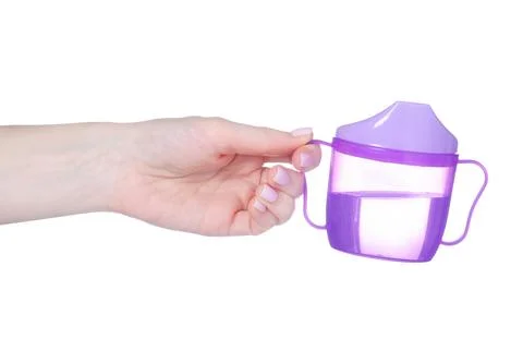 Children's drinking mug in hand Stock Photos