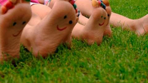 Children's feet drawn on the grass. Selective focus. Stock Footage 295867935
