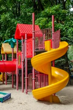 Children's game complex with a spiral slide on the right Stock Photos