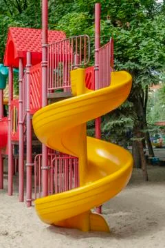 Children's game complex with a spiral slide on the right Stock Photos