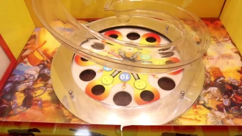 Children's games in the mall by inserting coins and getting tickets Stockbeeldmateriaal 243573054