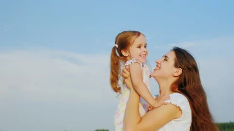 Children's games. Mom plays with her daughter, tossing it high in the sky Stock Footage 66040327