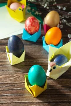 Children's gift Easter egg wrapping on a wooden table. Handmade. Stock Photos