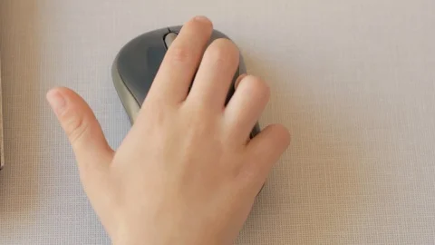 Children's hand clicks on a computer mouse Stock Footage 98134875