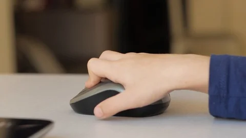 Children's hand clicks on a computer mouse Stock Footage 98134876