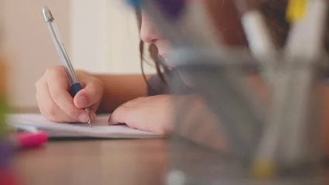 Children's hand close-up. the child uses a pencil to practice writing letters.  Video stock 249235515
