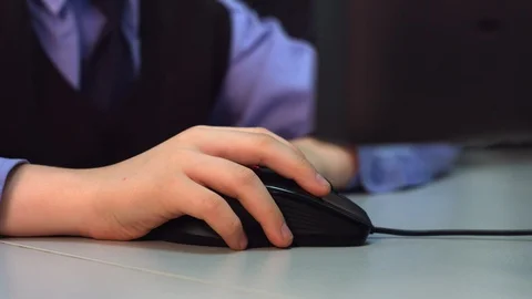 Children's hand on a computer mouse Stock Footage 128168653