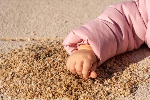 Children's hand takes a handful of sand Stock Photos