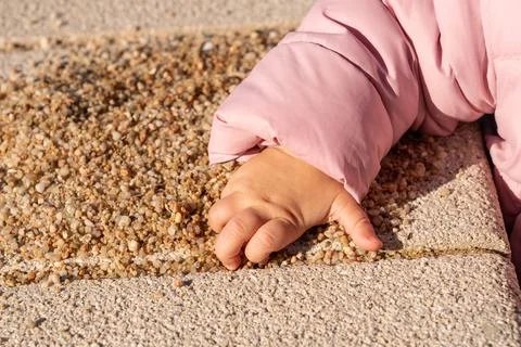 Children's hand takes a handful of sand Stock Photos