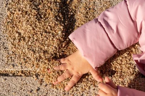 Children's hand takes a handful of sand Stock Photos