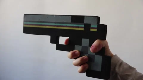 Children's hand with weapons minecraft. Close-up of a hand on a white backgr Stock Footage 147103756