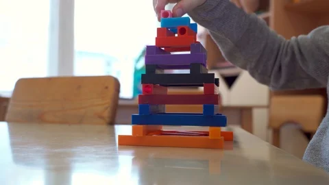 Children's hands are engaged in creativity. Falling tower Stock Footage 98921720