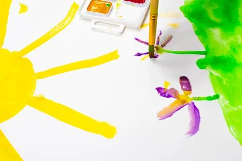 Children's hands are painted with a brush and watercolors. Children's creativity Stock Photos