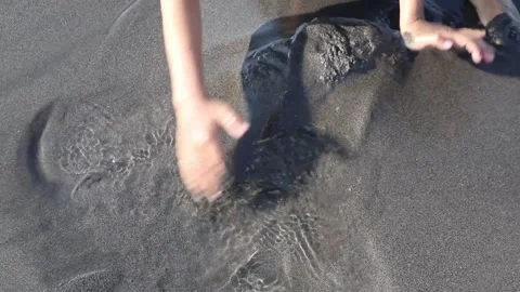 Children's hands are playing on the beach sand during the day. Stock Footage 162295715