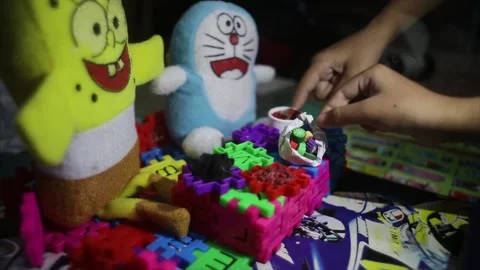 Children's hands are playing with Funny Blocks, Spongebob Dolls and Stock Footage 250237231