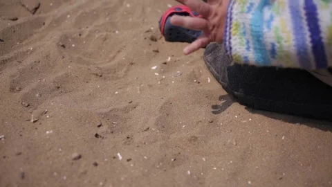 Children's hands are playing with sand on the beach. Stock Footage 90446858