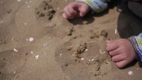 Children's hands are playing with sand on the beach. Stock Footage 90446923