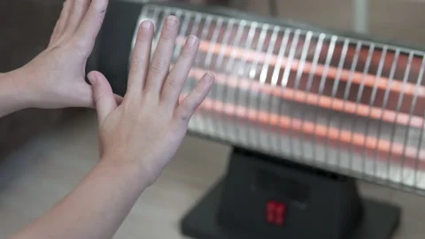 Children's hands are warming up on the electronic battery at home Video stock 232593815
