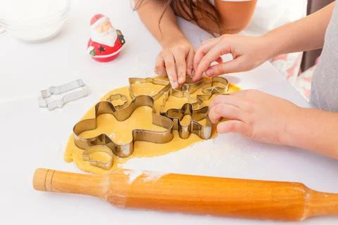 Children's hands, close-up, on a white table, cut out from the dough Christmas Stock Photos