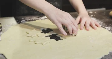Children's hands cut out the shape on the cookie dough. Stock Footage 85853325