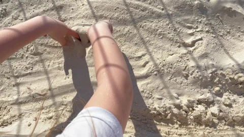 Children's hands draw a heart shape on the sand, a sign of love and care for Stock Footage 241080904
