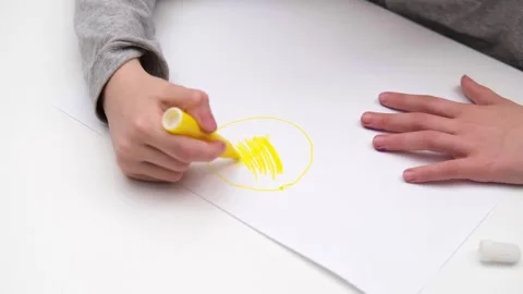 Childrens hands draw on a white sheet of paper close up Stock Footage 304955637