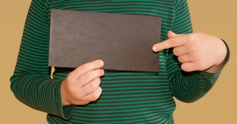 Children's hands hold an empty black envelope Stock Photos