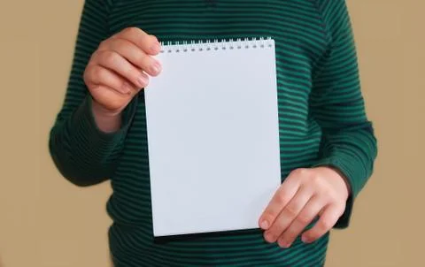 Children's hands hold an empty white envelope Stock Photos