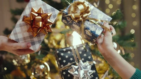 Children's Hands Hold Three Beautifully Wrapped Christmas Gifts Stock Footage 255291335