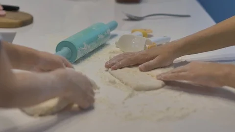 Children's hands make figures from the dough,on a white table,close-up. Stock Footage 127429350